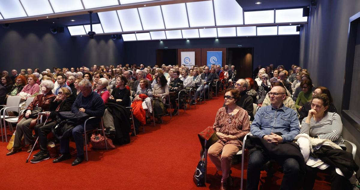 Sobre estas líneas, público asistente a la conferencia. A la izquierda, cola en el exterior en el momento del cierre de puertas por aforo completo. | LUISMA MURIAS