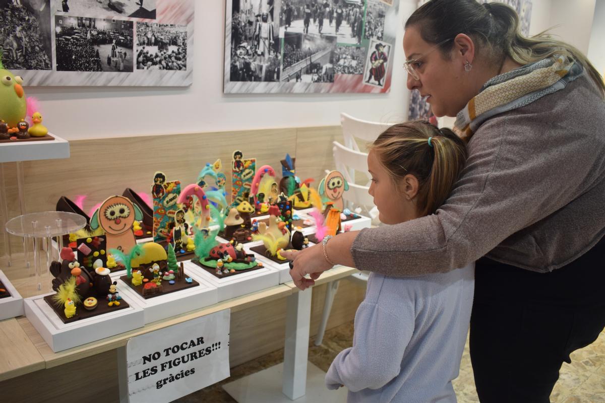 Una nena mirant figures de xocolata a la Dolceria Pujol