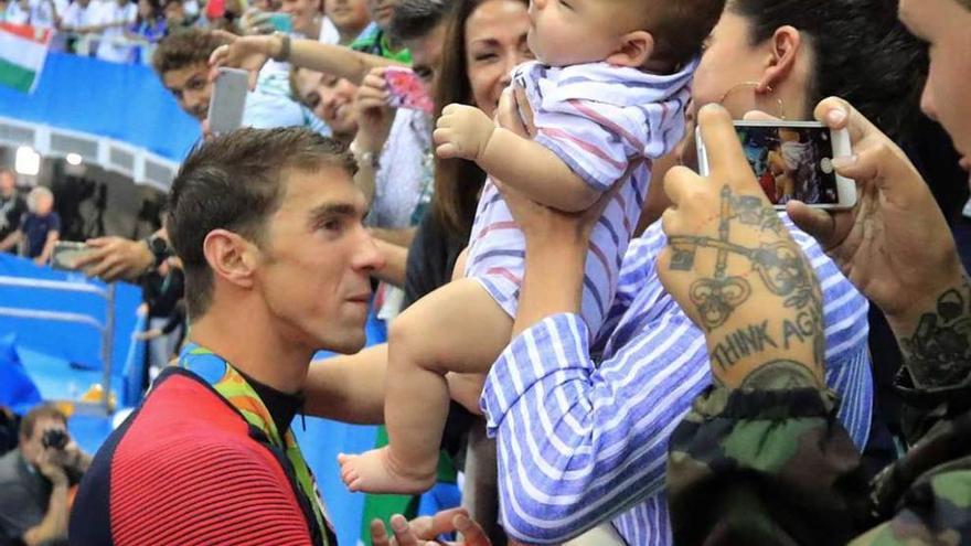 Michael Phelps, con su hijo Boomer tras ganar el oro en los 200 metros marioposa.