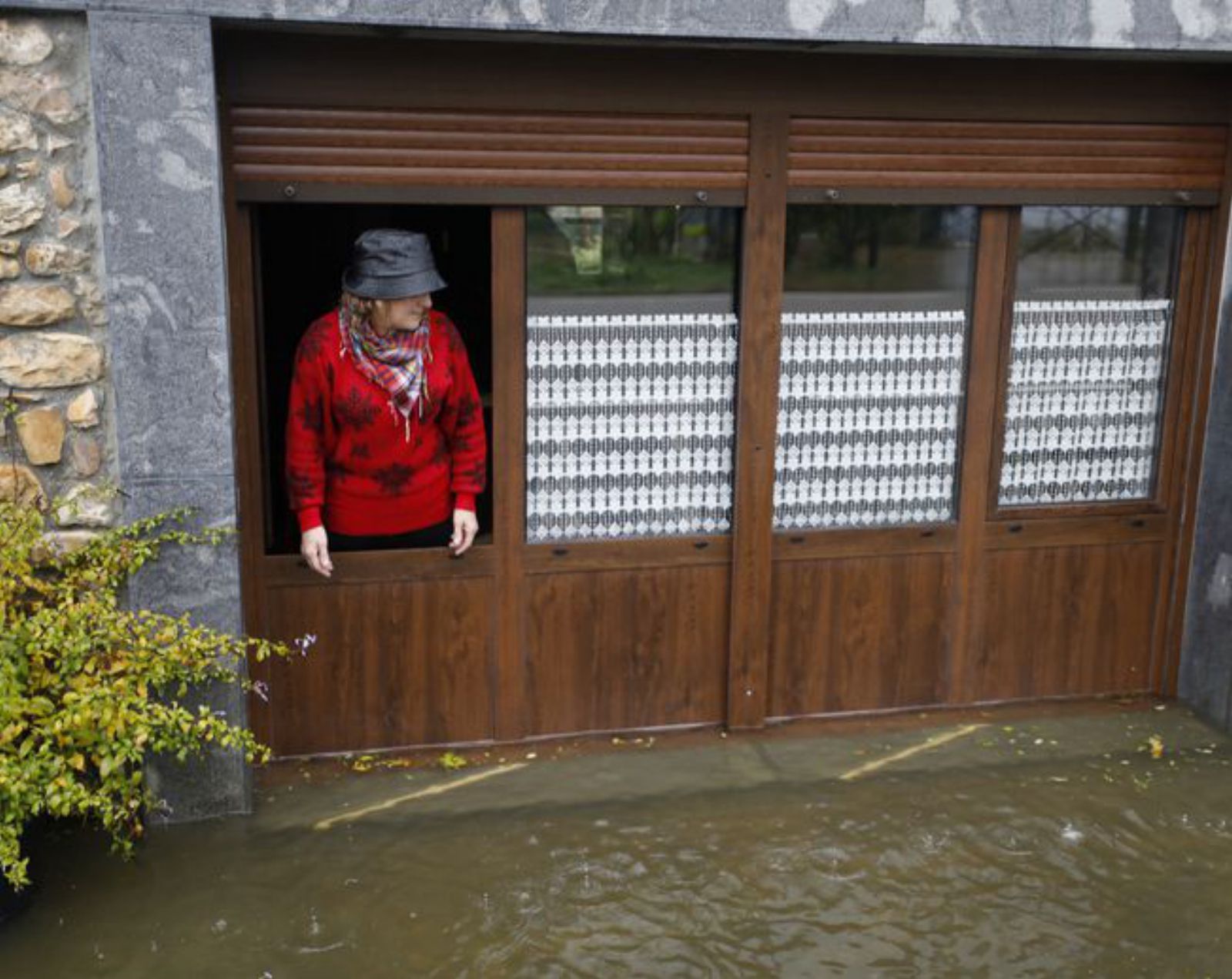 Una vecina de Triongo observa cómo el agua alcanza su casa.