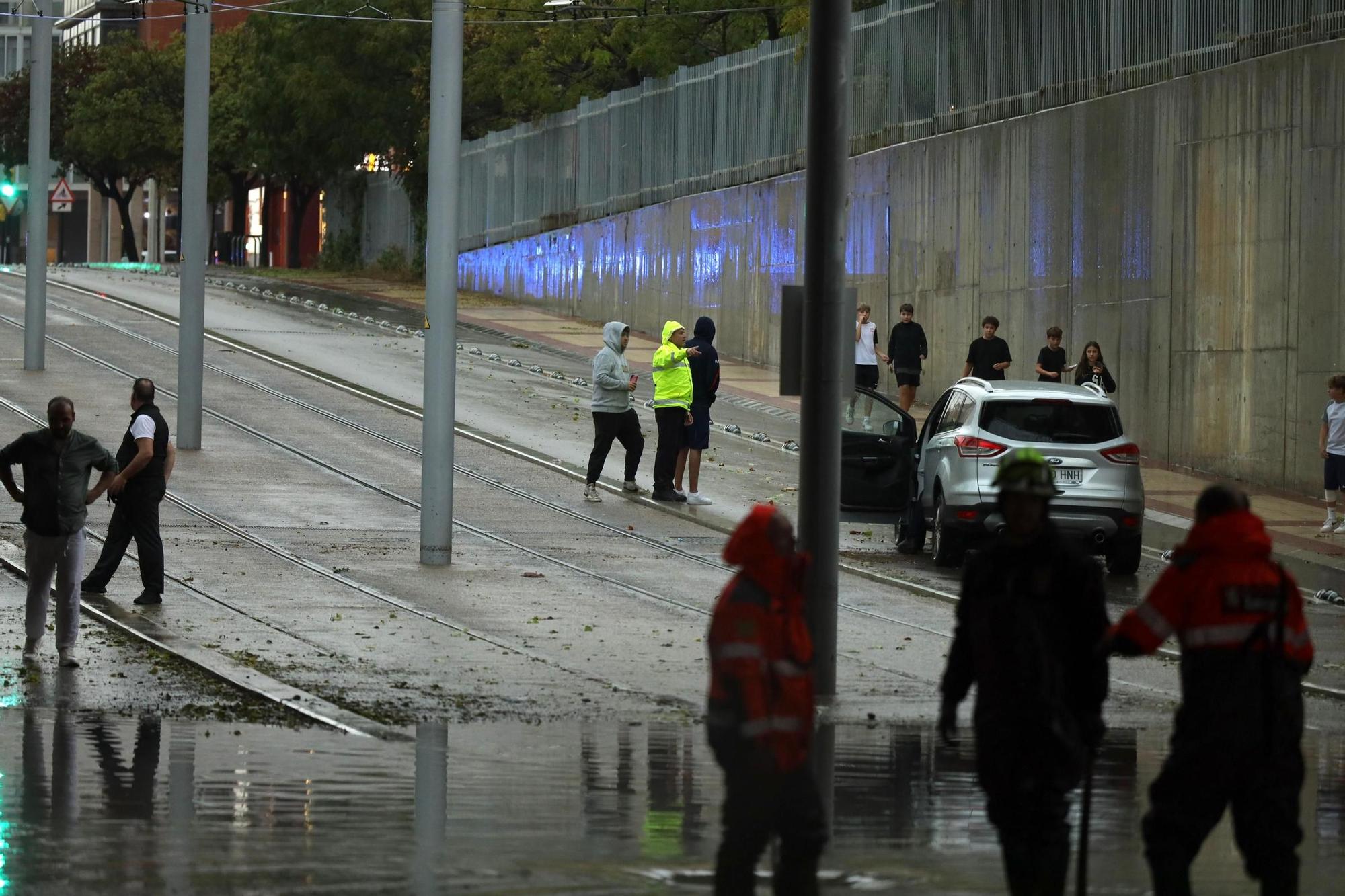 En imágenes I La lluvia anega varias calles de Zaragoza y obliga a intervenir a los bomberos