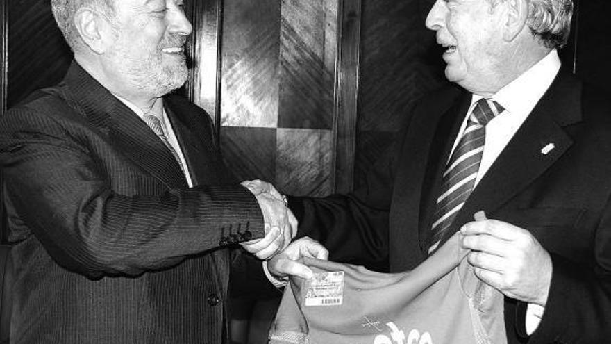 Gabino de Lorenzo, a la izquierda, recibe de Dámaso Bances una camiseta del Oviedo para su nieto Mateo.