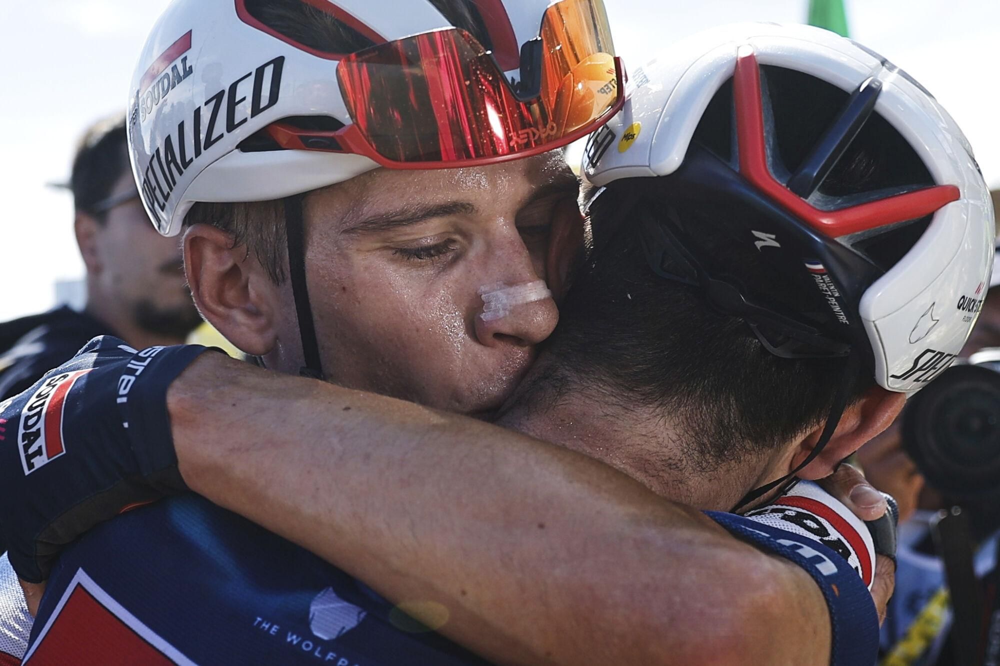 France's Valentin Paret Peintre, seen from back, is hugged by teammate Belgium's Ilan van Wilder, left, after Paret Peintre won the sixteenth stage of the Tour de France cycling race over 171.5 kilometers (106.6 miles) with start in Montpellier and finish on the Mont Ventoux, France, Tuesday, July 22, 2025. (Martin Divisek/Pool Photo via AP). POOL PHOTO