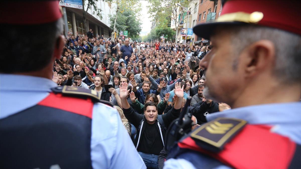 Los Mossos ante las personas que se hallan frente a la escuela Tabor, de Barcelona.