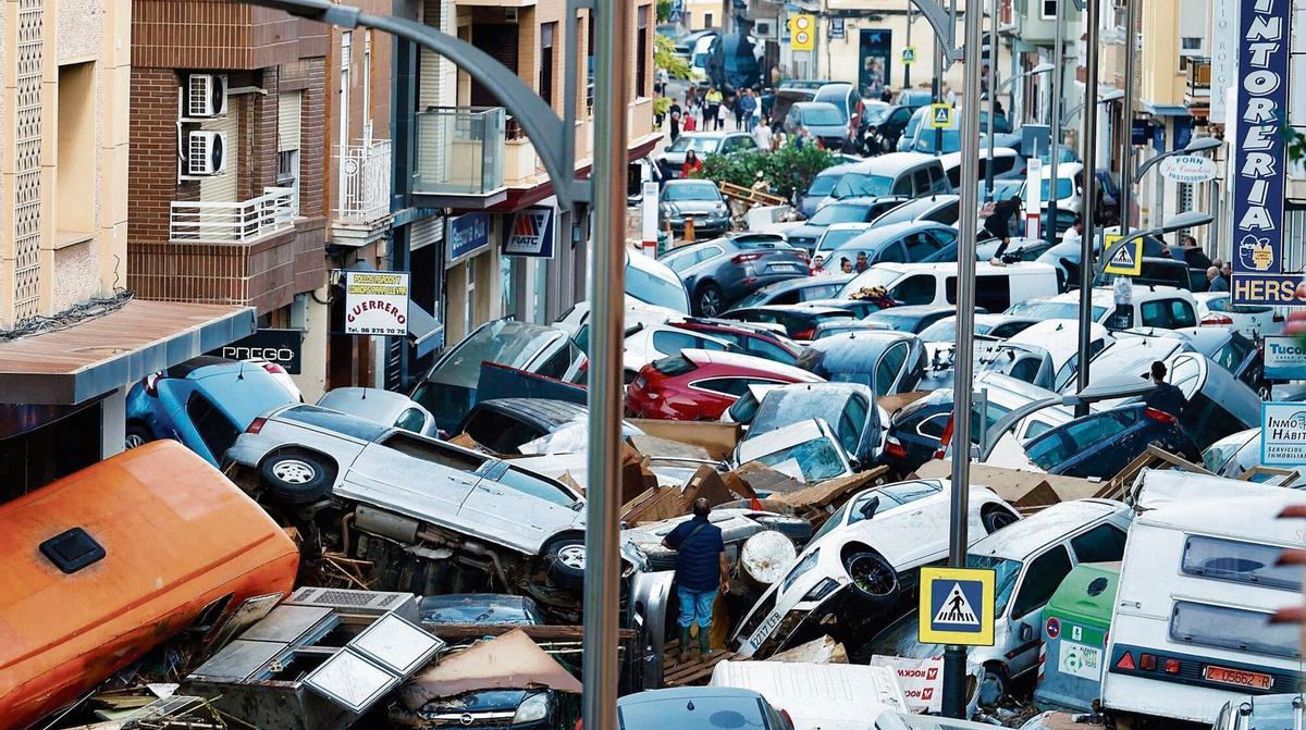 Una de las calles de Sedaví ,cuatro días después de la barrancada cuando los coches arrastrados impedían incluso la salida de los domicilios. / J. M. LÓPEZ Un dels carrers de Sedaví ,quatre dies després de la barrancada, quan els cotxes arrossegats impedien fins i tot la sortida dels domicilis. / J. M. LÓPEZ Valencia DANA Inundaciones Sedaví Horta Sud VLC