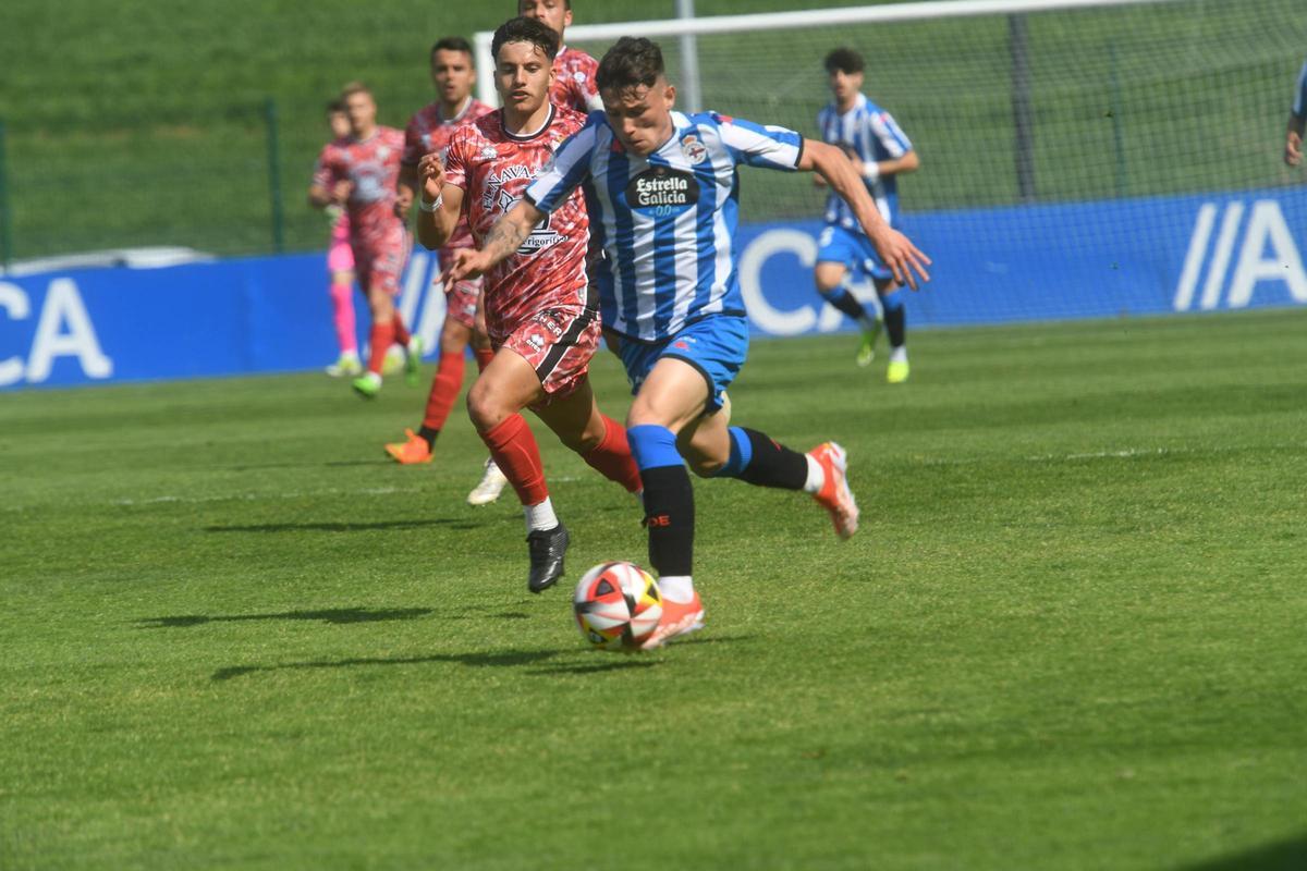 Kevin Sánchez conduce la pelota perseguido por un jugador del Guijuelo.