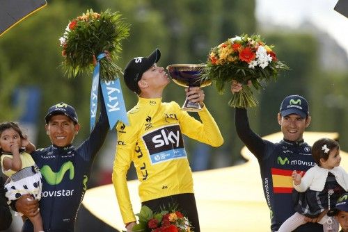 Team Sky rider Froome of Britain, the race leader's yellow jersey, celebrates his overall victory on the podium after the final 21st stage of theTour de France cycling race