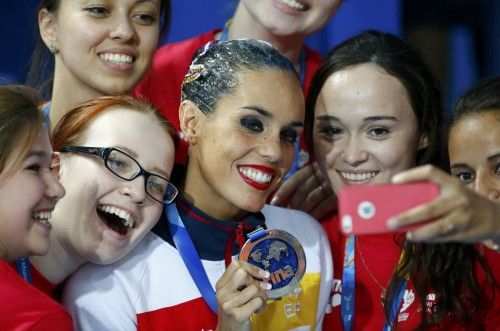Silver medal winner Ona Carbonell of Spain makes a selfie with volunteers after the synchronised swimming solo technical final at the Aquatics World Championships in Kazan