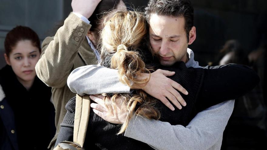 Familiares y amigos se abrazan a su llegada a la capilla ardiente.