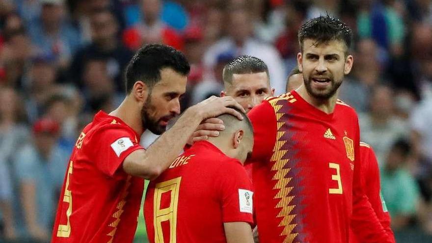 Busquets y Piqué consuelan a Koke tras fallar el lanzamiento del penalti. // Efe