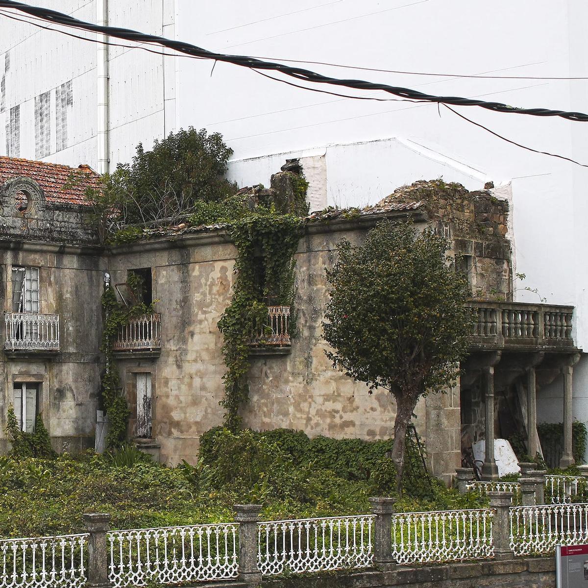 Los restos del Pazo da Carrela, anexos a la Casa Torre de Escuredo y cortados por la mitad por el bloque de pisos de reciente construcción