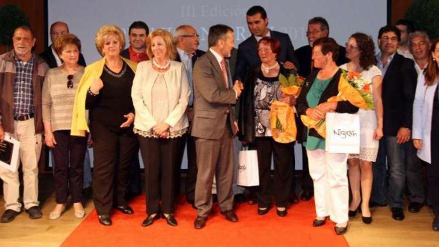 Los premiados con colaboradores y dirigentes políticos tras la entrega de premios, a la que acudieron más de 200 personas.  // Marta G. Brea