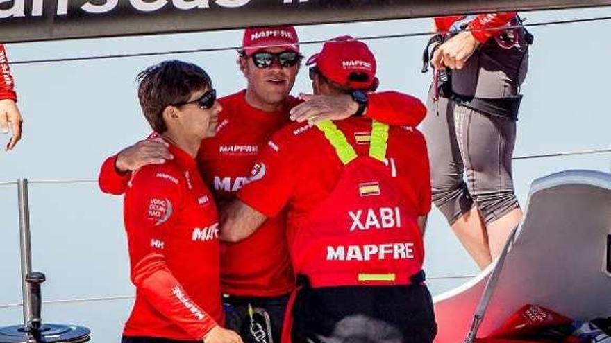 Los tripulantes del Mapfre se abrazan tras la regata. // María Muíña