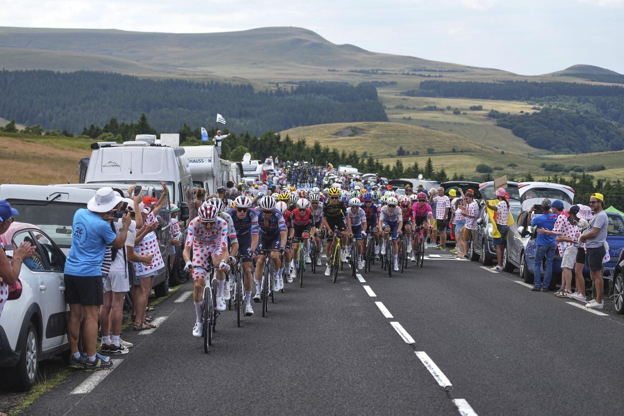 Belgium's Tim Wellens, wearing the best climber's dotted jersey, sets the pace for the pack during the tenth stage of the Tour de France cycling race over 165.3 kilometers (102.7 miles) with start in Ennezat and finish in Le Mont-Dore Puy de Sancy, France, Monday, July 14, 2025. (AP Photo/Thibault Camus)