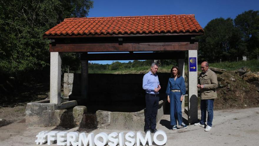 La conselleira y el alcalde (izquierda) en una visita a un lavadero rehabilitado.