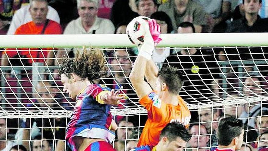 Cuéllar bloca un balón adelantándose a los barcelonistas Puyol y Villa, y a su compañero Botía.