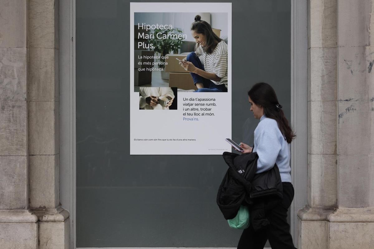 Una mujer pasa por delante de una oferta hipotecaria