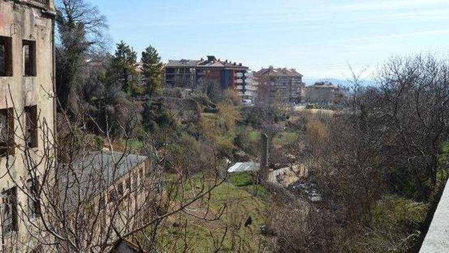 Imatge del forat vist des de la Ronda Moreta amb la façana de la vella fàbrica de la farinera a l&#039;esquerra