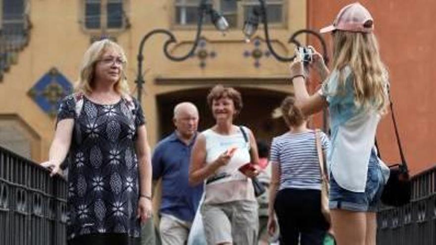 Turistes fotografiant-se davant les façanes de l&#039;Onyar.