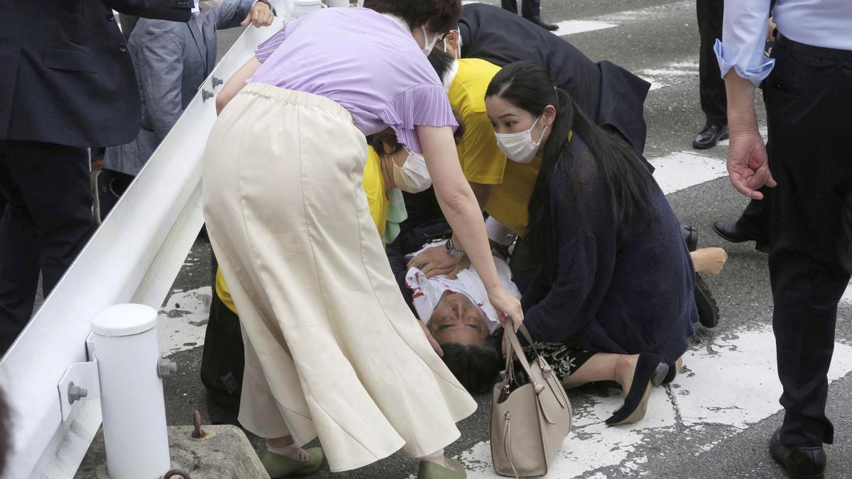 Former Japanese prime minister Shinzo Abe lies on the ground after apparent shooting during an election campaign in Nara, Japan