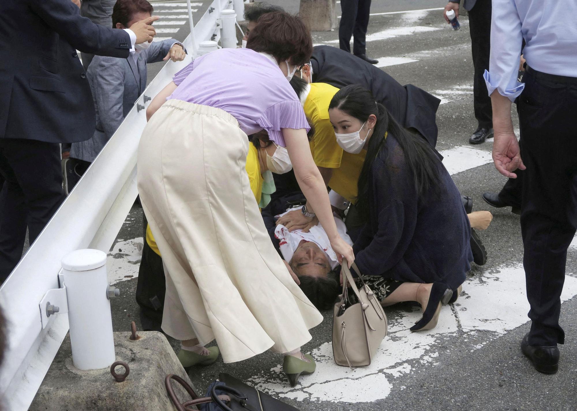 Former Japanese prime minister Shinzo Abe lies on the ground after apparent shooting during an election campaign in Nara, Japan