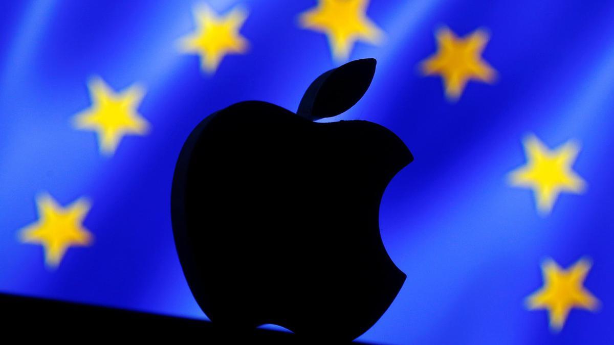 A 3D printed Apple logo is seen in front of a displayed European Union flag in this illustration