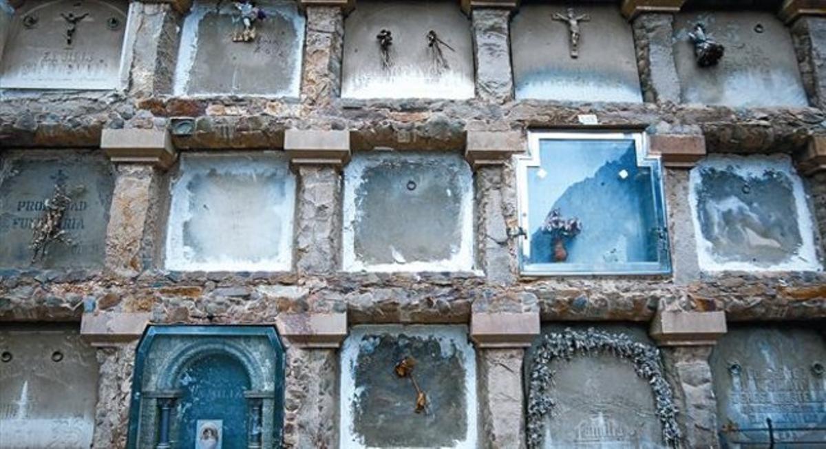 Algunos nichos de beneficencia junto a otros costeados por los familiares de los difuntos, en un bloque de tumbas del cementerio barcelonés de Montjuïc.