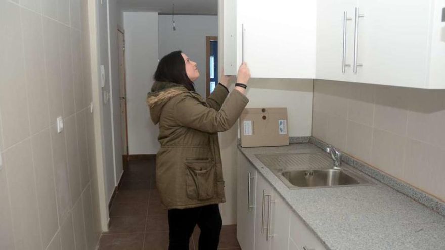 Eva Matarranz abre una de las alacenas de su nueva cocina. // Rafa Vázquez