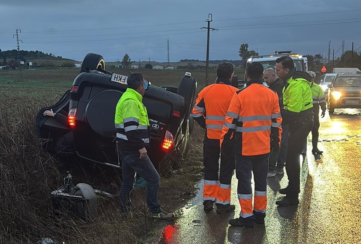 Efectivos atendiendo a la joven que se encontraba dentro del coche volcado.