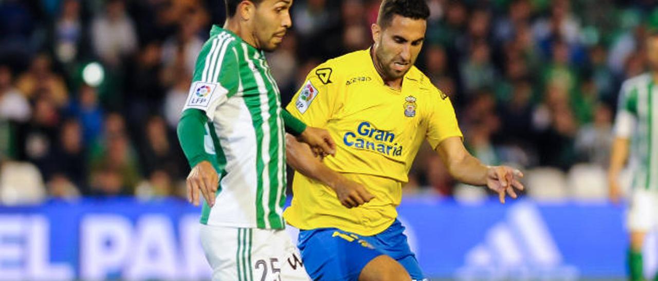 El centrocampista de la UD Las Palmas Ángel Montoro pelea un balón ante Petros, brasileño del Real Betis.