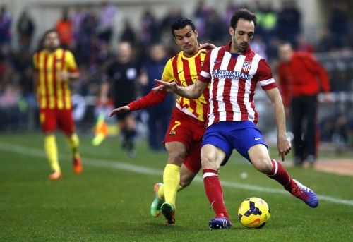 Barcelona's Pedro Rodriguez fights for the ball with Atletico Madrid's Juanfran during their Spanish first division soccer match in Madrid