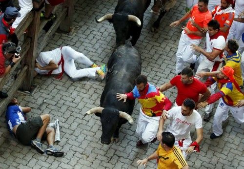 Runners lead Conde de la Maza fighting bulls at the entrance to the bullring during the sixth running of the bulls of the San Fermin festival in Pamplona