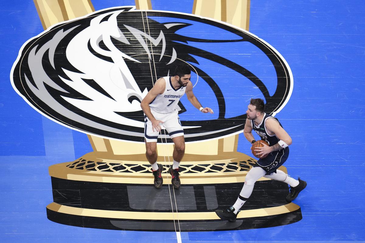 Dallas Mavericks guard Luka Doncic, right, drives against Memphis Grizzlies forward Santi Aldama during the second half of an Emirates NBA Cup basketball game, Tuesday, Dec. 3, 2024, in Dallas. The Mavericks won 121-116. (AP Photo/Julio Cortez)
