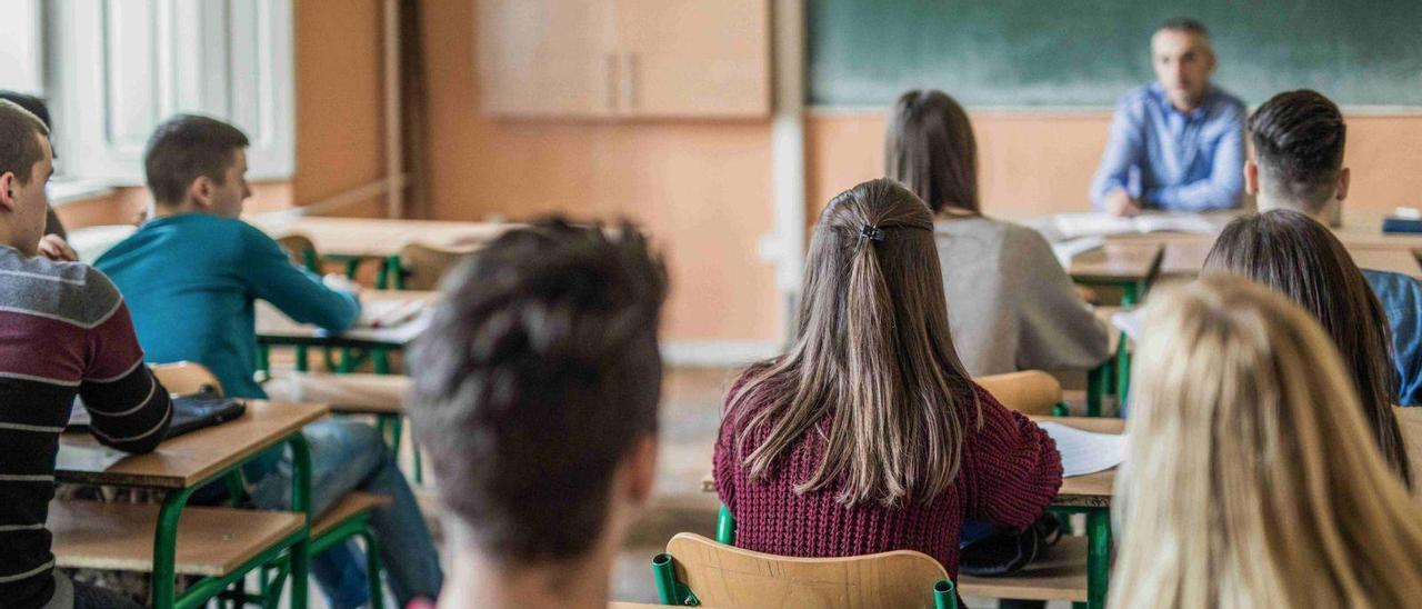 Estudiantes de Secundaria atienden a su profesor durante una de las clases del turno de mañana en un centro público.