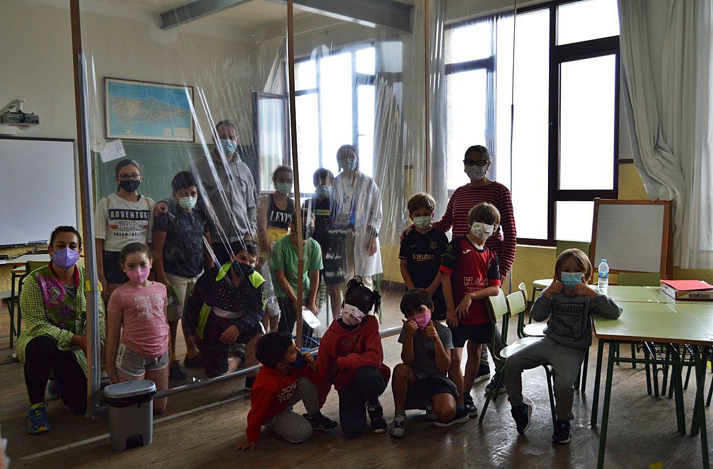 Alumnos y profesores del centro de Lastres, ayer, separados por una mampara transparente. | Olaya Pena