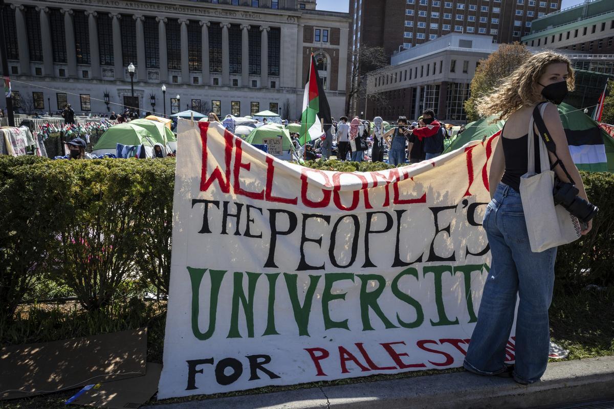 A sign is displayed  in front of the tents erected at the Pro-Palestine protest encampment at the Columbia University campus in New York on Monday April 22, 2024. (AP Photo/Stefan Jeremiah)