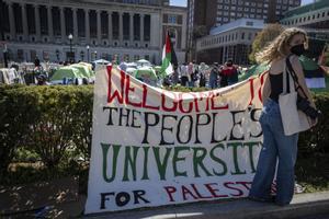 A sign is displayed  in front of the tents erected at the Pro-Palestine protest encampment at the Columbia University campus in New York on Monday April 22, 2024. (AP Photo/Stefan Jeremiah)