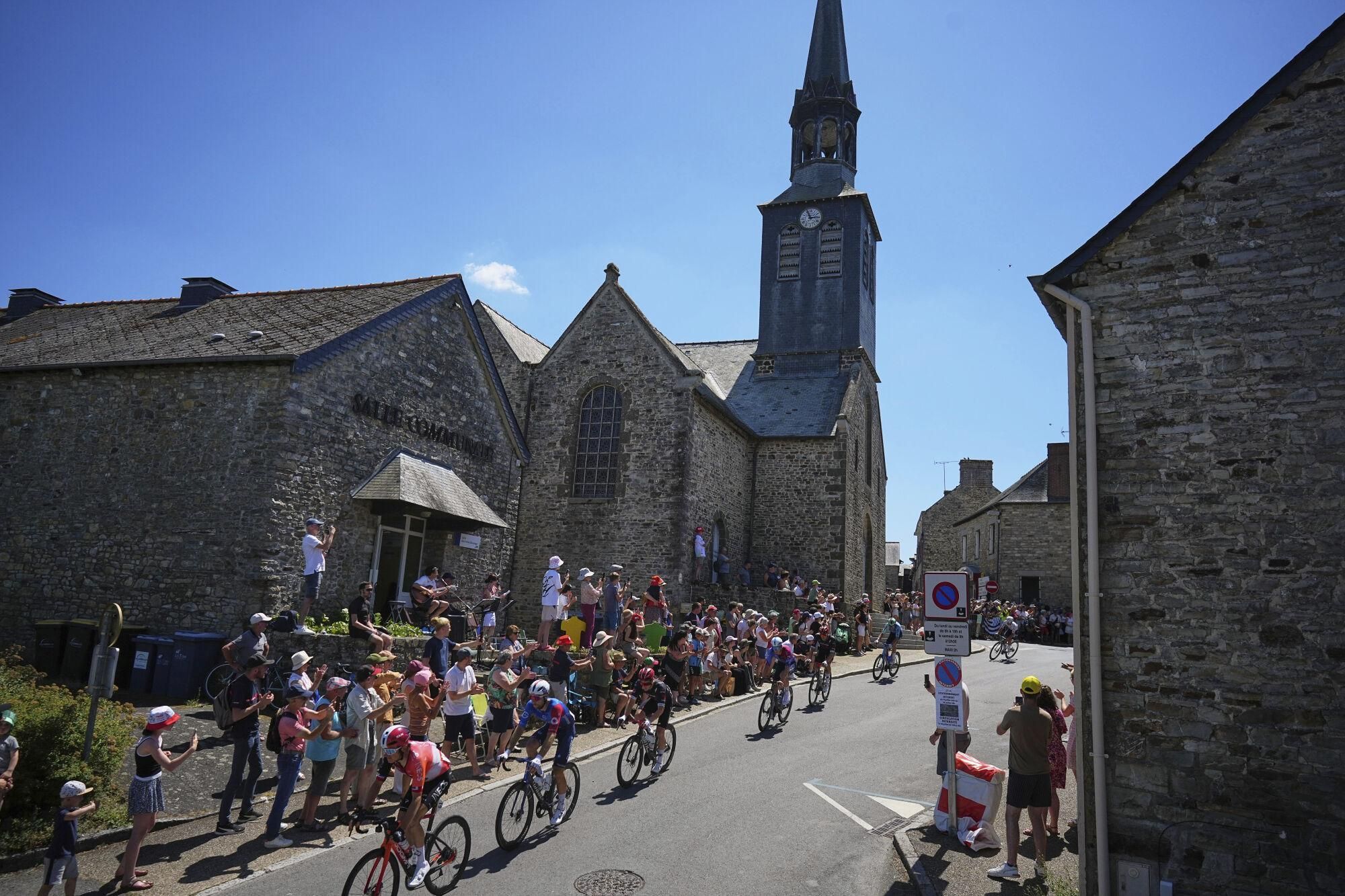 The pack rides during the eighth stage of the Tour de France cycling race over 171.4 kilometers (106.5 miles) with start in Saint-Meen-le-Grand and finish in Laval Espace Mayenne, France, Saturday, July 12, 2025. (AP Photo/Thibault Camus)