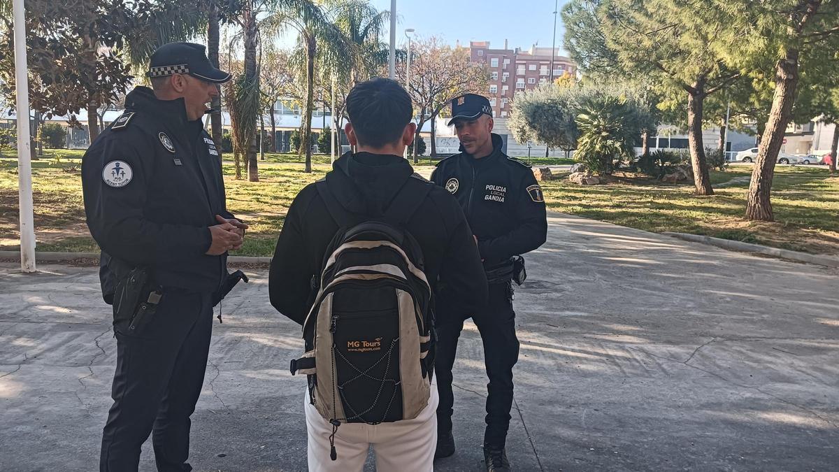 Dos agentes de la Policía Local de la unidad con un joven.