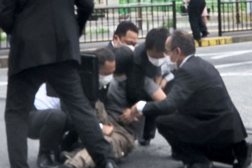 This screen grab shows a man being detained near the location where former Japanese Prime Minister Shinzo Abe was shot, in Nara