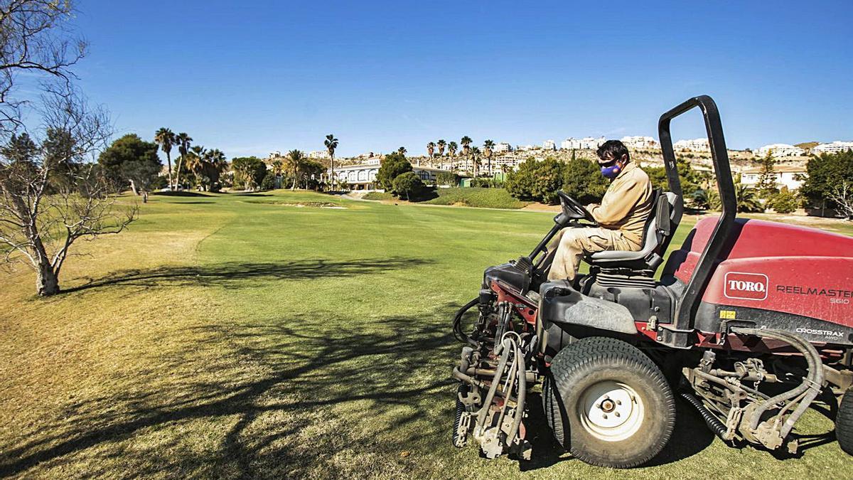 Personal de mantenimiento en el campo de golf Bonalba, uno de los veinte cerrados. | MANUEL R. SALA