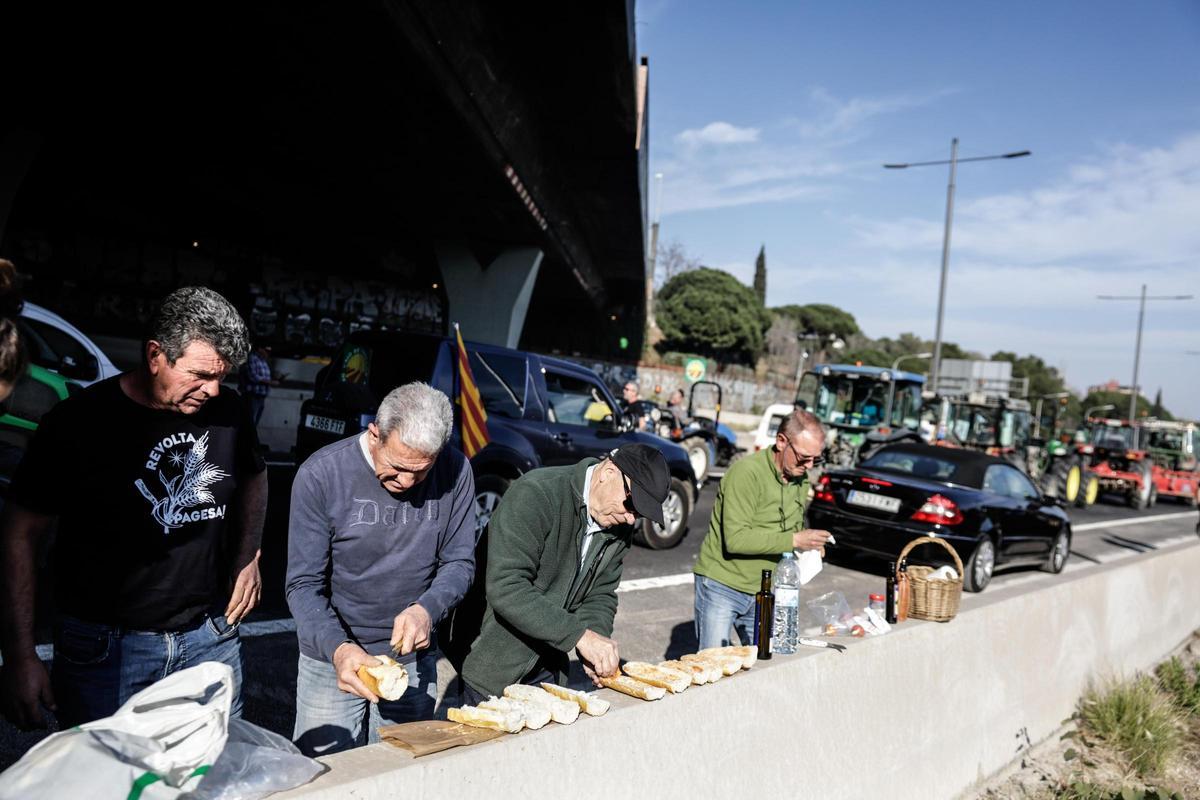 Agricultores preparan comida en la Diagonal, a su llegada a Barcelona.