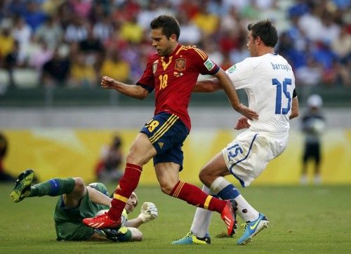 Italy's goalkeeper Gianluigi Buffon makes a save against Spain's Jordi Alba as teammate Andrea Barzagli challenges during their Confederations Cup semi-final soccer match at the Estadio Castelao in Fortaleza