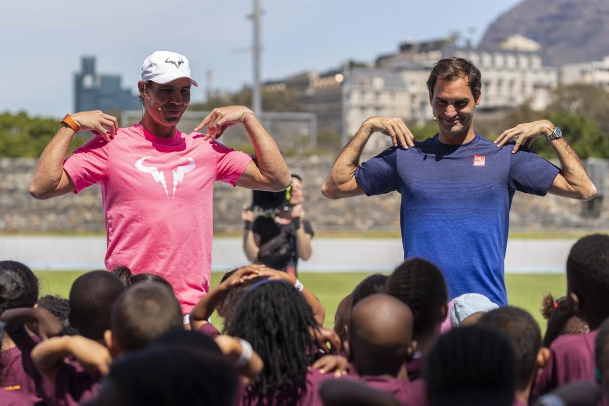 Cape Town (South Africa), 07/02/2020.- Roger Federer of Switzerland (R) and Rafael Nadal of Spain (L) take part in a Roger Federer Foundation Learning through Play session with South African children ahead of the Match in Africa Cape Town charity event, Cape Town, South Africa 07 February 2020. Roger Federer will play Rafael Nadal in the Match in Africa Cape Town charity event at Cape Town Stadium on 07 February 2020. Presented by Rolex the Match in Africa is for the benefit of the Roger Federer foundation. (Tenis, Sudáfrica, España, Suiza) EFE/EPA/NIC BOTHMA