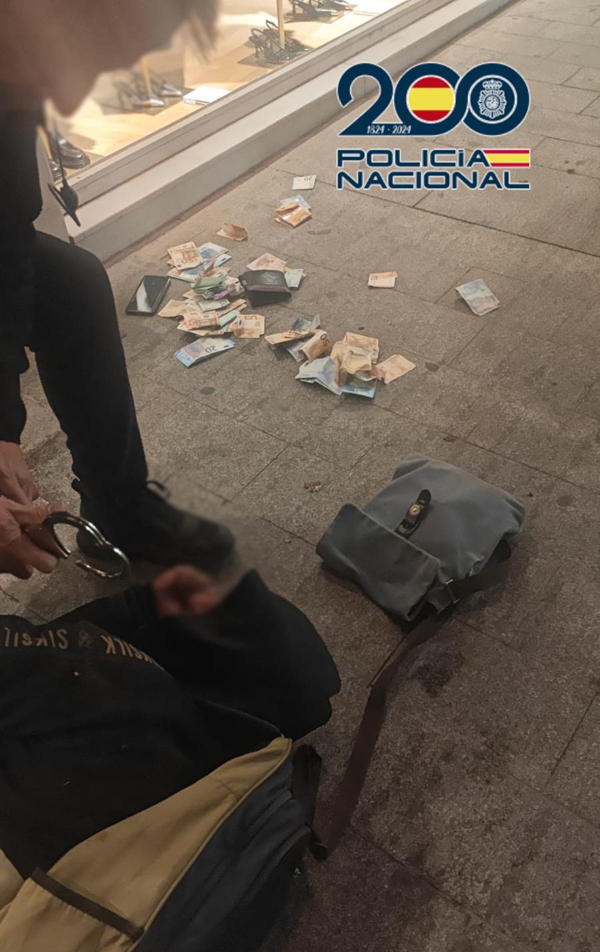 Imagen del momento de la detención, con el dinero y el bolso recuperado por la Policía en Alicante.