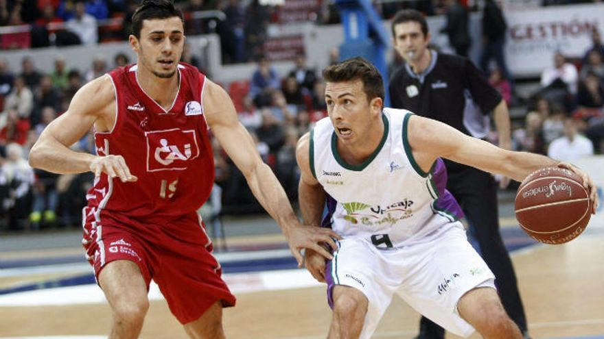 El escolta norteamericano del Unicaja Ryan toolson (d) con el balón ante el alero del CAI ZAragoza Pere Tom s, durante el partido correspondiente a la decimosexta jornada de Liga que disputan en el pabellón Príncipe Felipe.