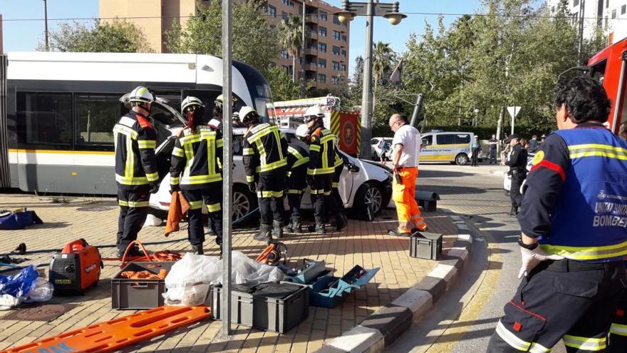 Los bomberos tratan de excarcelar a la mujer herida.