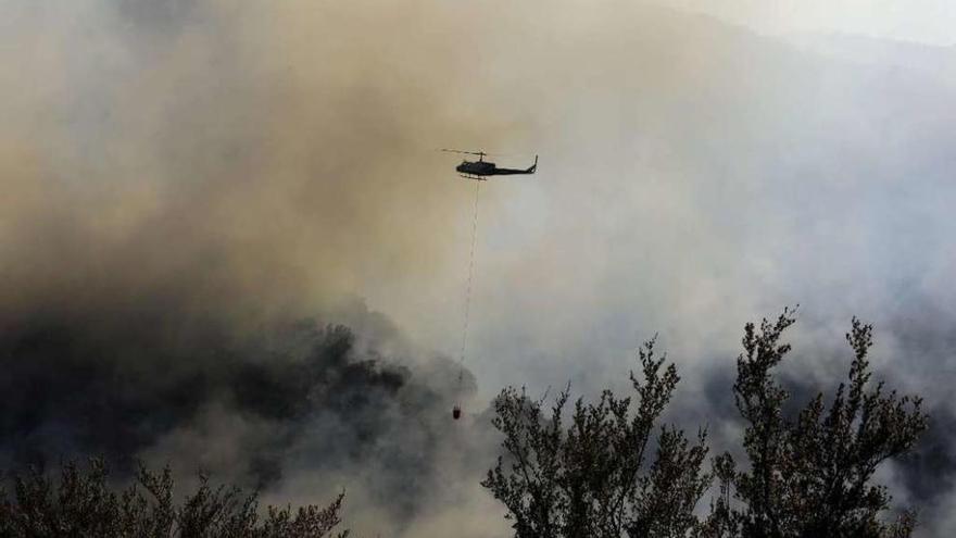 Un helicóptero sobrevuela una de las zonas castigadas por el incendio.