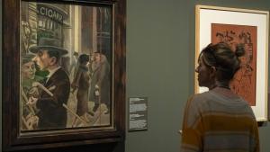 Una visitante observar Escena callejera, de George Grosz