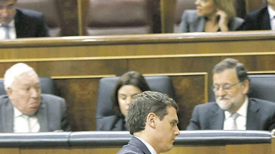 Rivera pasa ante el escaño de Rajoy en el Pleno del miércoles. // Efe